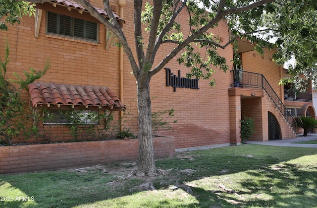 5246 N 20th St Unit B1, Phoenix, AZ 85016 - view of home's exterior featuring stairs, a yard, and brick siding