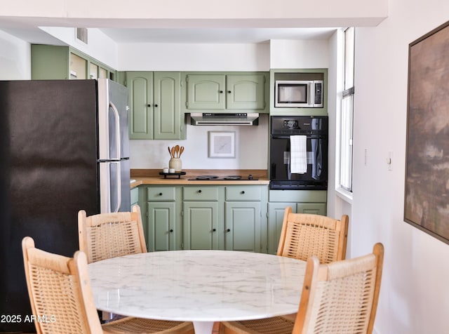 5246 N 20th St Unit B1, Phoenix, AZ 85016 - kitchen with green cabinetry, stainless steel appliances, ventilation hood, and light countertops