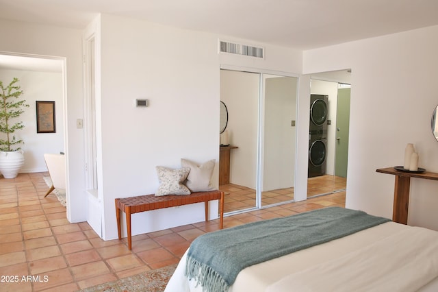 5246 N 20th St Unit B1, Phoenix, AZ 85016 - bedroom with stacked washing machine and dryer, a closet, and light tile patterned floors