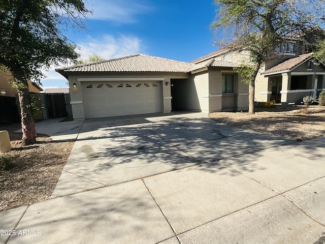 ranch-style house with an attached garage, stucco siding, a tile roof, and concrete driveway
