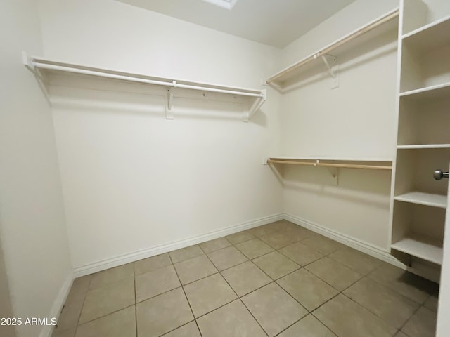 walk in closet with tile patterned floors