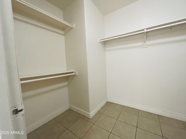spacious closet with tile patterned floors