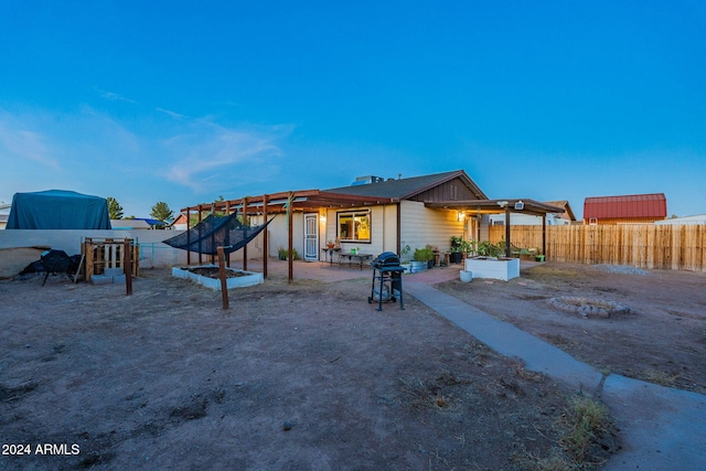 back of property with a pergola and a patio area