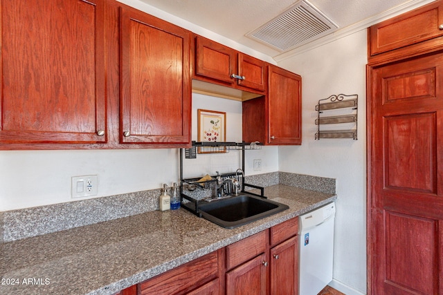 kitchen with a textured ceiling, sink, white dishwasher, and dark stone counters