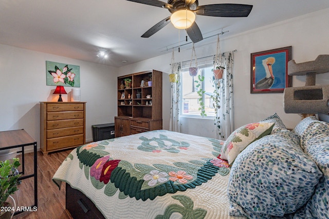 bedroom with wood-type flooring and ceiling fan