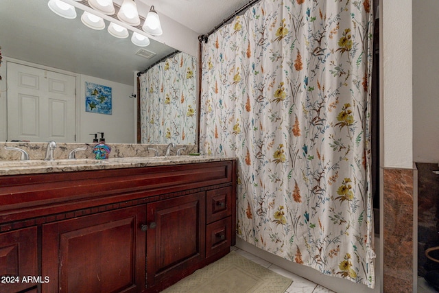 bathroom featuring vanity, a textured ceiling, and a shower with curtain