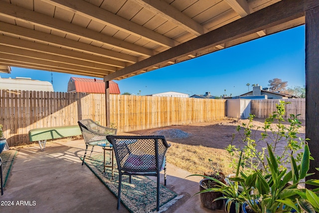 view of patio featuring a storage shed