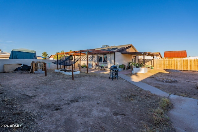 rear view of house featuring a patio and a pergola