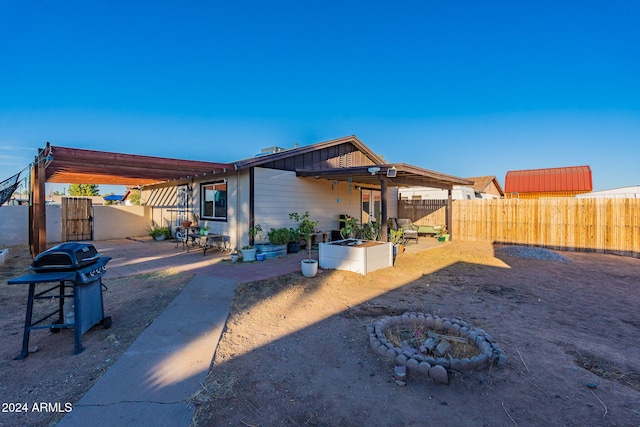 back of house featuring a patio and an outdoor fire pit