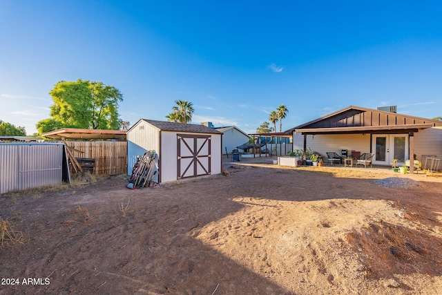 exterior space featuring a storage unit, a patio, and french doors