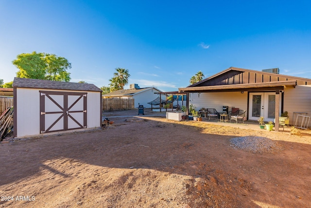 back of property with a patio and a storage unit