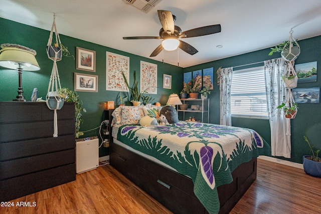 bedroom featuring hardwood / wood-style floors and ceiling fan