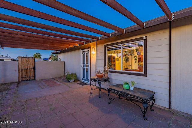 patio terrace at dusk with a pergola