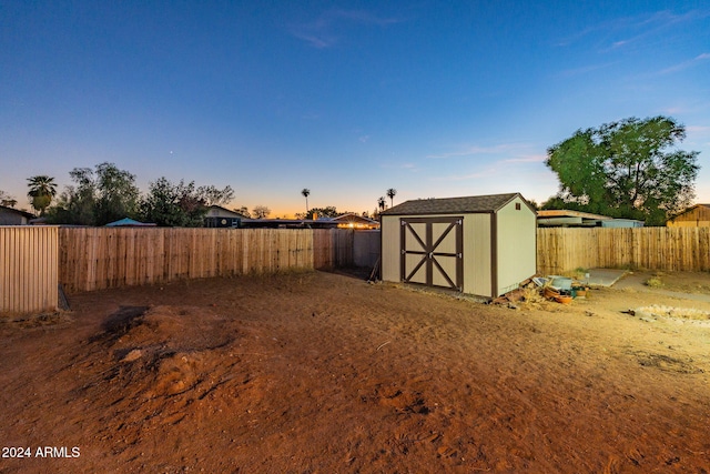 yard at dusk with a storage shed