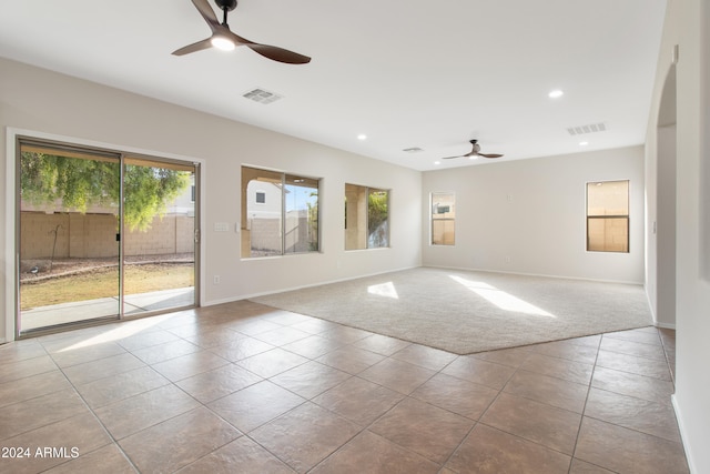 carpeted empty room featuring ceiling fan