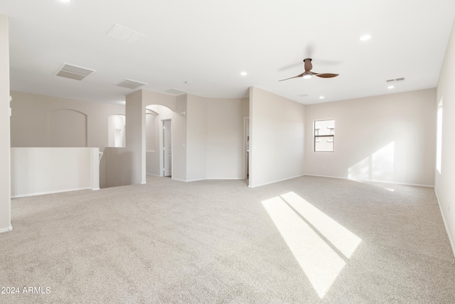 unfurnished room featuring light colored carpet and ceiling fan