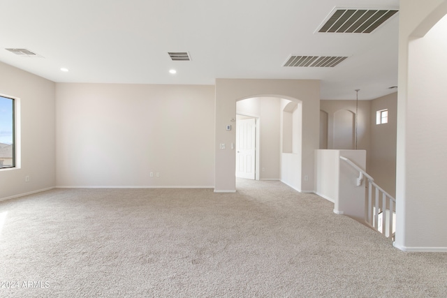 carpeted empty room featuring a healthy amount of sunlight