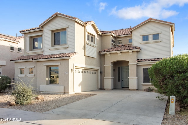 mediterranean / spanish-style house with a garage