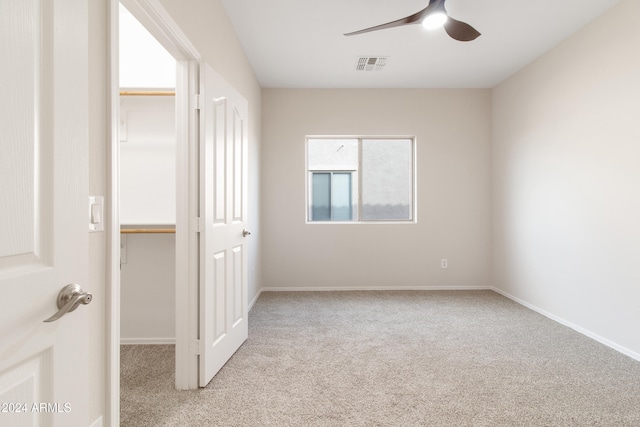 spare room featuring light carpet and ceiling fan