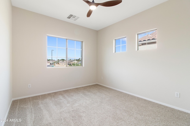 empty room featuring carpet floors and ceiling fan