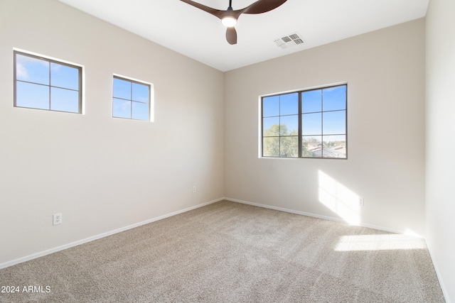 carpeted empty room featuring plenty of natural light and ceiling fan