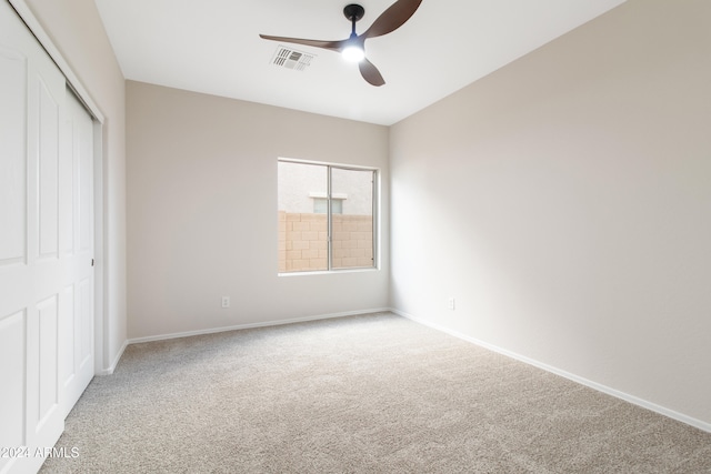 unfurnished bedroom featuring carpet, a closet, and ceiling fan