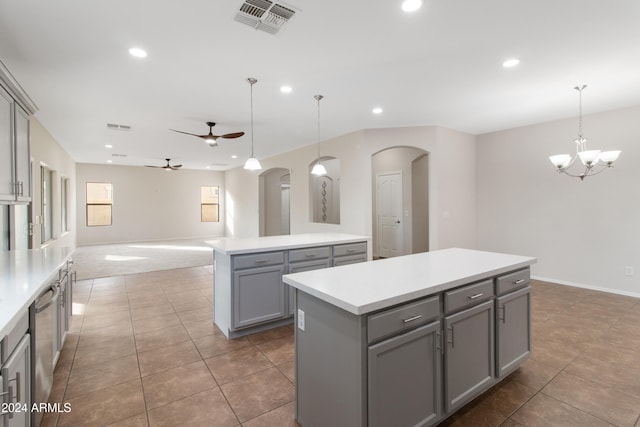 kitchen with dishwasher, a kitchen island, hanging light fixtures, and gray cabinetry