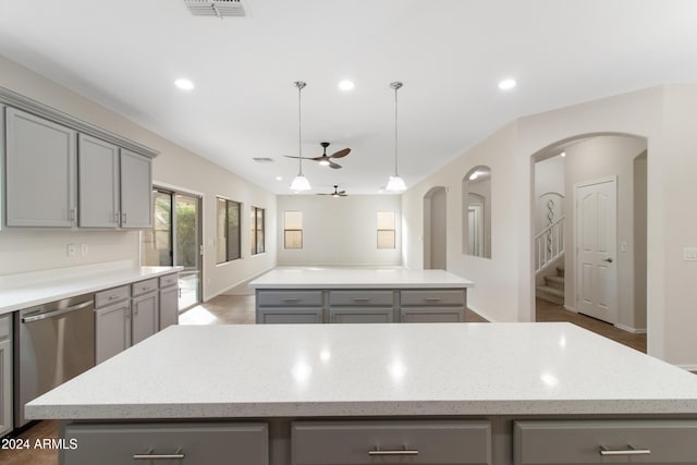 kitchen with gray cabinets, dishwasher, a center island, and ceiling fan