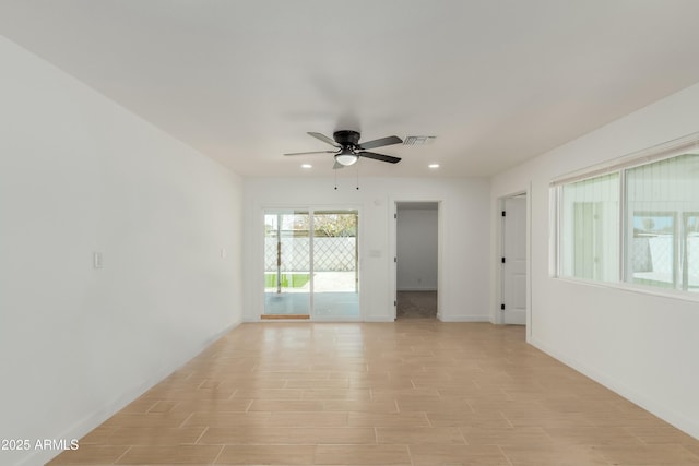 empty room featuring light wood finished floors, visible vents, baseboards, ceiling fan, and recessed lighting