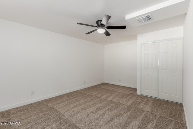 unfurnished bedroom featuring a closet, carpet, visible vents, and baseboards