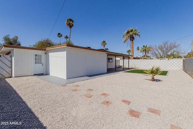 view of front of house with a patio area and fence