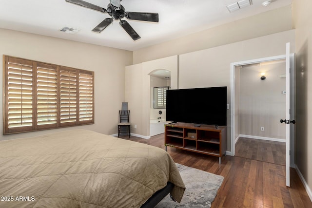 bedroom with visible vents, arched walkways, baseboards, and wood finished floors