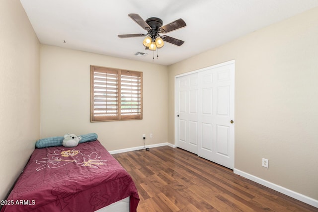 bedroom featuring baseboards, visible vents, and wood finished floors