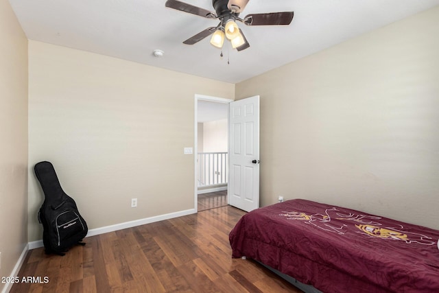 bedroom featuring baseboards, ceiling fan, and wood finished floors