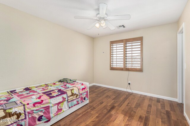 bedroom featuring ceiling fan, baseboards, visible vents, and wood finished floors