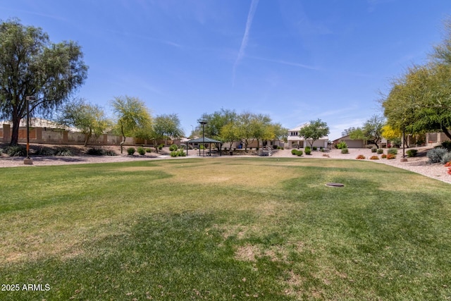 view of home's community featuring a gazebo, fence, and a yard