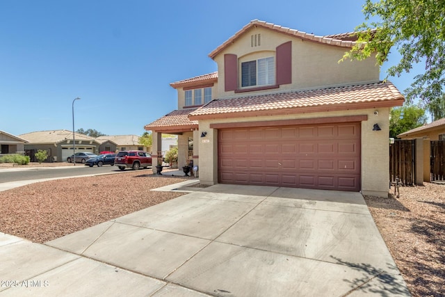 view of front of property with a garage, fence, stucco siding, driveway, and a tile roof