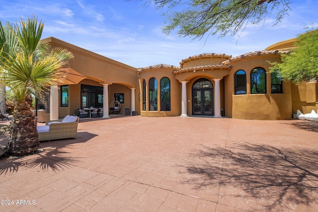 back of house featuring french doors, an outdoor hangout area, and a patio area