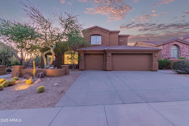 14056 E Desert Cove Ave, Scottsdale, AZ 85259 - mediterranean / spanish house featuring concrete driveway, stucco siding, a garage, and a tiled roof