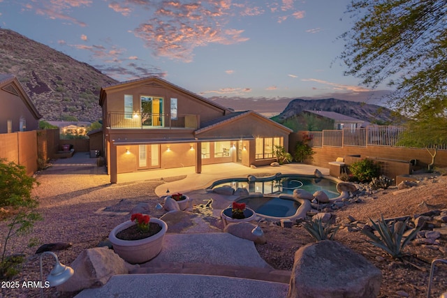 14056 E Desert Cove Ave, Scottsdale, AZ 85259 - back of house featuring an in-ground hot tub, a balcony, a patio area, and a fenced backyard