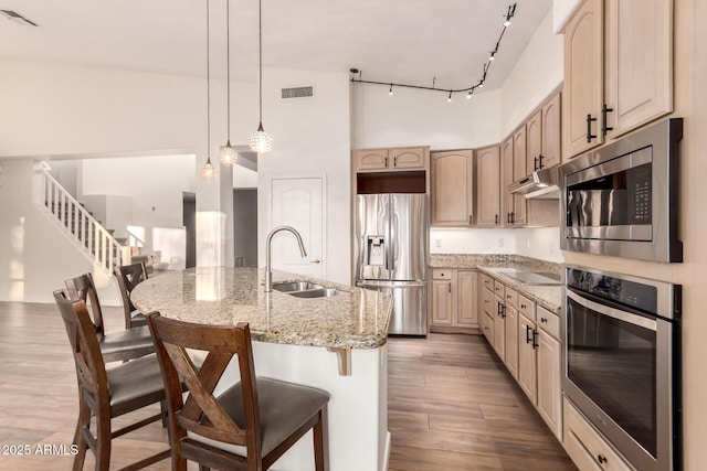 14056 E Desert Cove Ave, Scottsdale, AZ 85259 - kitchen with stainless steel appliances, a sink, a high ceiling, track lighting, and a kitchen breakfast bar