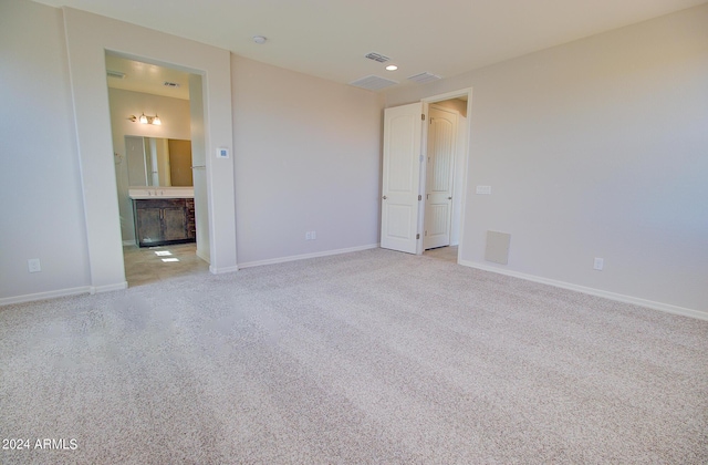 unfurnished room featuring light carpet