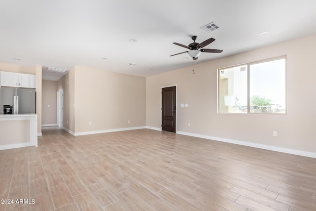 unfurnished room with ceiling fan and light hardwood / wood-style floors