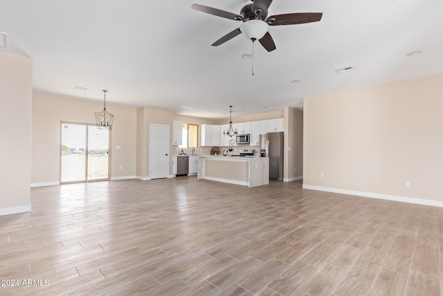 unfurnished living room with ceiling fan and light wood-type flooring