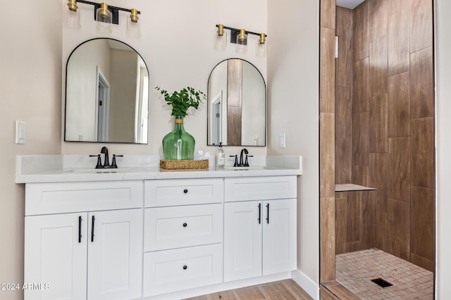 bathroom with vanity, wood-type flooring, and walk in shower