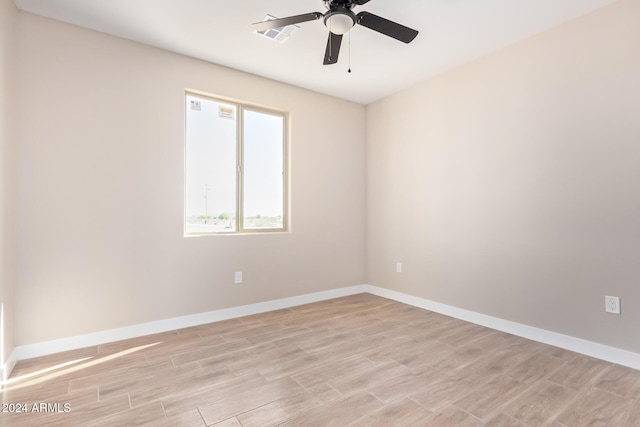 spare room featuring light hardwood / wood-style flooring and ceiling fan