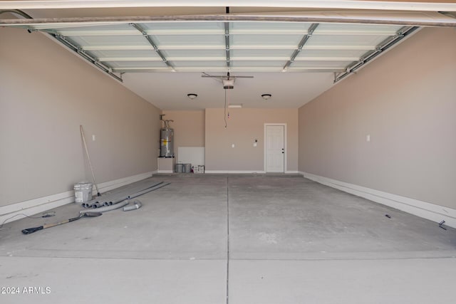 garage featuring water heater and a garage door opener