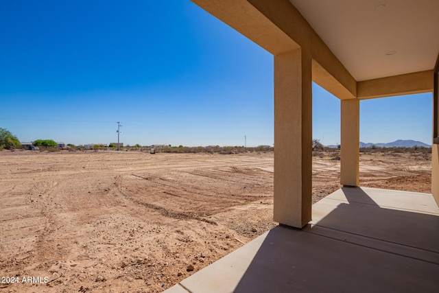 view of yard featuring a rural view and a patio area