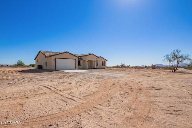 view of front of house featuring a rural view and a garage