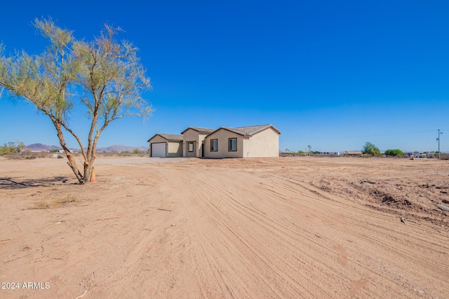 view of front facade with a rural view and a garage